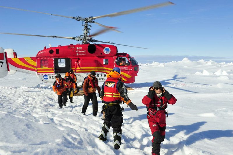 The first group of passengers from the trapped Russian ship MV Akademik Shokalskiy exit a Chinese rescue helicopter Thursday in this photo provided by China’s Xinhua News Agency. 