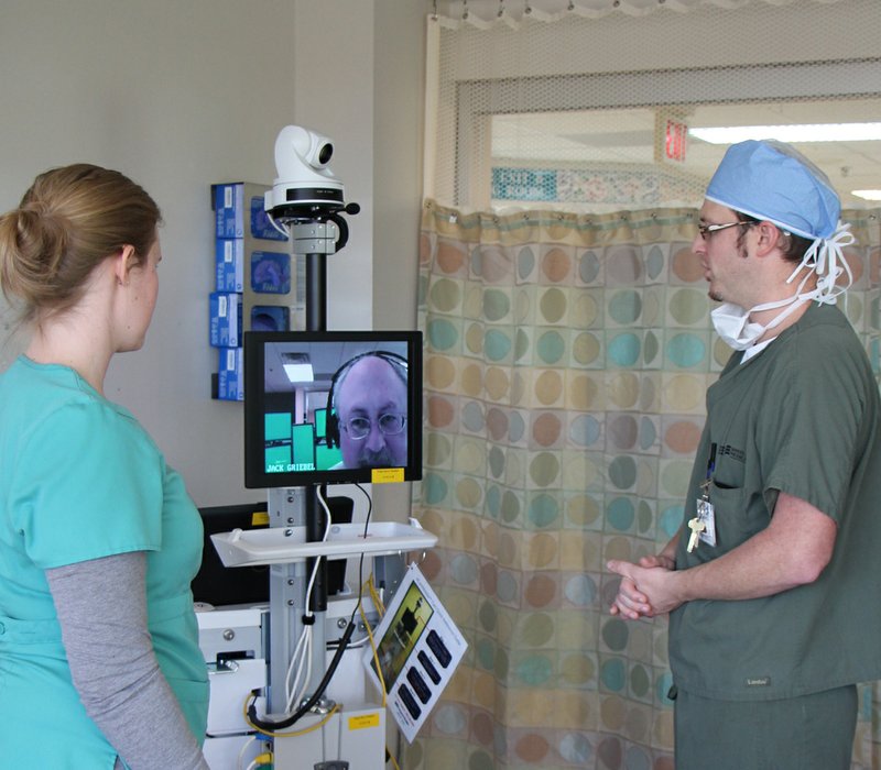 Dr. Chris Steele, an anesthesiologist at White River Medical Center in Searcy, and Rachel Vaughn, a registered nurse in the hospital’s intensive-care unit, discuss a patient’s health with a physician from Baptist Health’s Command Center in Little Rock through a two-way monitoring system called eICU care.