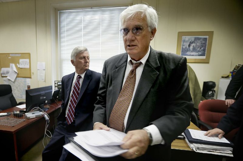 Department of Finance and Administration Director Richard Weiss handed out copies of the state’s revenue forecasts last month when Gov. Mike Beebe (left) and he stopped by the press room at the Capitol. ON Friday, after reviewing the latest revenue figures, Weiss said Arkansas’ economy is “just muddling along.” 