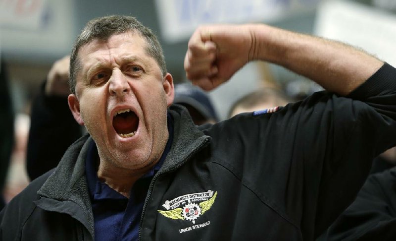 Seattle machinists union member Rob Curran chants “no” at a rally Thursday against Boeing’s proposed contract. Unions urged members to vote down the deal Friday, saying it surrenders too much. 