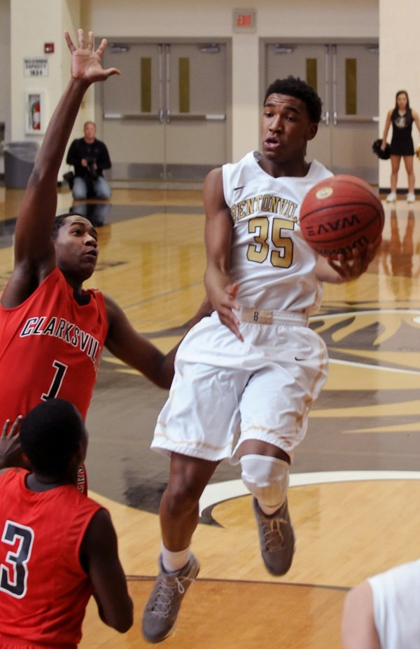 Bentonville's Malik Monk attempts a shot while being guarded by Clarksville's Jarren Thompson during the basketball game in Bentonville's Tiger Arena on Tuesday November 26, 2013.