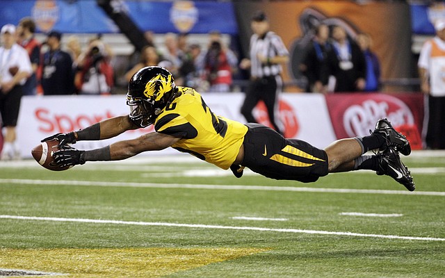 Missouri running back Henry Josey leaps into the end zone for the fi rst of his two fourth-quarter touchdowns during the Tigers’ 41-31 victory over Oklahoma State in the Cotton Bowl on Friday night. 