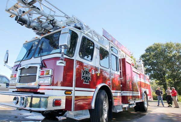 City of Fayetteville firefighter inspect a new demonstration E-One HP 78 Ladder Truck Monday morning Oct. 7, 2013 in Fayetteville. Members of the department had the opportunity to drive and demo the ladder truck brought in by E-One, of Ocala Fla., for possible purchase by the department next year.