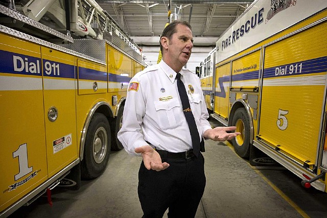 In this Dec. 20, 2013 photo, Fire Chief Darrel Fournier speaks to a reporter in Freeport, Maine. Fire chiefs and lawmakers are working to protect the system of volunteer firefighting that has served rural America for more than a century but is threatened by an ambiguity in President Barack Obamas health care law. The volunteers are considered employees for tax purposes, leaving open the question of whether they fall under the health care laws requirement that employers with more than 50 workers provide insurance for them. (AP Photo/Robert F. Bukaty)