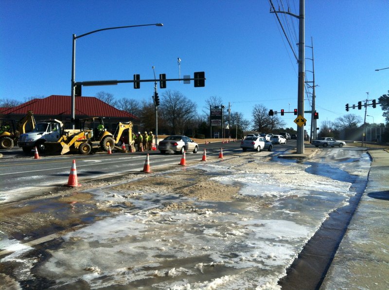 A mix of ice and slush develops Monday, Dec. 6, 2014, from an underground water pipe leak at the intersection of West Markham Street and Rodney Parham Road in Little Rock.