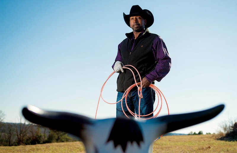 Cowboy Wefus Tyus of Twin Groves uses a roping dummy for practice.