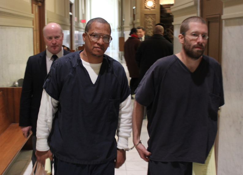 Darrell Dennis, left, is escorted from court Tuesday morning after a hearing.
