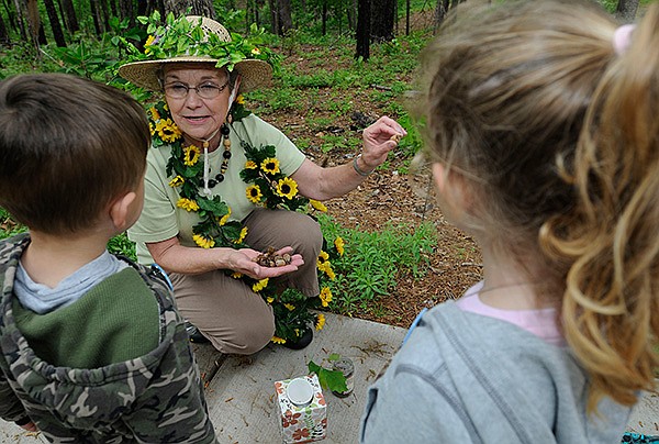 Diane Gately of Rogers portrays “Mother Nature” when she reads to children at Hobbs State Park Conservation Area near Rogers. Saturday’s story time theme will be “Bird Beak Buffet.”