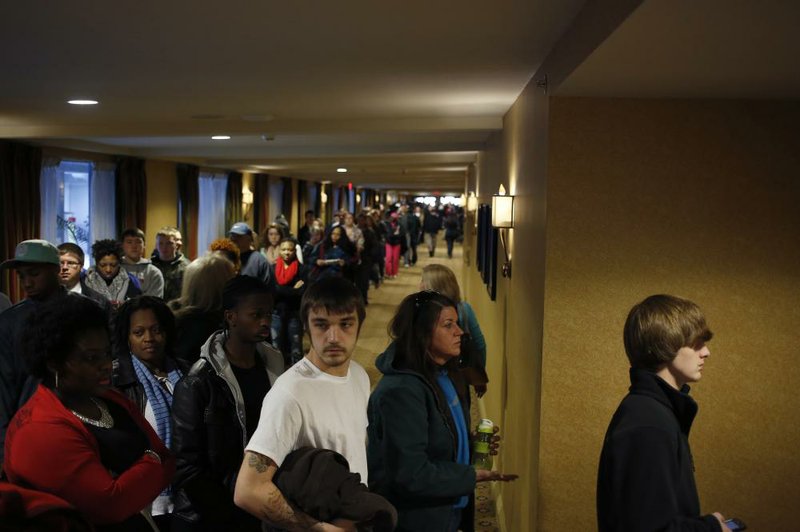 Job seekers line up Saturday to enter a job fair in Louisville, Ky., held by Kentucky Kingdom amusement park to hire seasonal summer workers. 