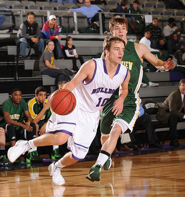 Fayetteville senior Luke Renner, left, drives past Springfield (Mo.) Parkview guard Autry Acord during the first half of play Monday, Nov. 25, 2013, at Bulldog Arena in Fayetteville. Visit photos.nwaonline.com for more photographs from the game.