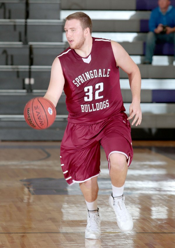 Springdale senior Josiah Wymer brings the ball up court during the first half of their game against Liberty (Mo.) in the Fayetteville Bulldog Classic on Thursday, Jan. 2, 2014, at Fayetteville High School.
