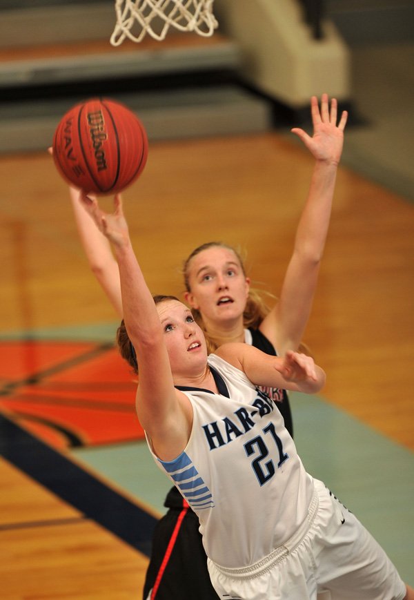 Har-Ber High school's Paige Redmond drives to the hoop past Pea Ridge defender Mikheala Cochran during Tuesday nights game at Har-Ber High School in Springdale.