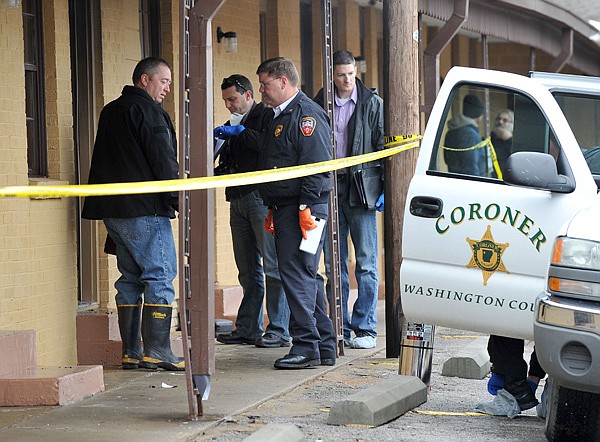 Washington County crime scene investigators  prepare to enter unit 120 of the Hi-Way Inn Motel on College Avenue in Fayetteville Thursday afternoon after a man was found dead after a fire in the unit.  A cleaning woman discovered the fire when she opened the door and saw black smoke billowing out, with the man on the bed and the mattress on fire.  The death will be handled as a homicide until investigators can rule out that possibility.
