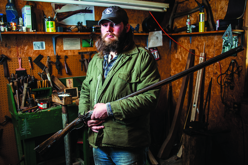 Daniel Casey, 26, of Center Hill made every part of the .40-caliber rifle he holds in his workshop. He has taken lessons from renowned gunsmith and bladesmith Hershel House in Woodbury, Ky.