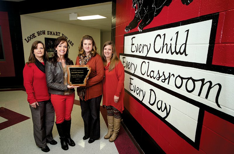 Cabot Middle School North faculty, from the left, Stephanie Harper, Principal Dawn Peeples, Terri Duncan and Wendi Pickard hold the Arkansas Diamond School to Watch plaque. The school has been re-designated as a 2014 Arkansas Diamond School to Watch.