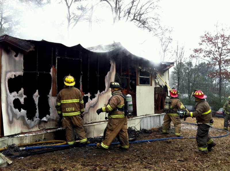 Fire officials work Friday, Jan. 10, 2014, to extinguish a blaze at 2921 Juarez Drive in Pulaski County.