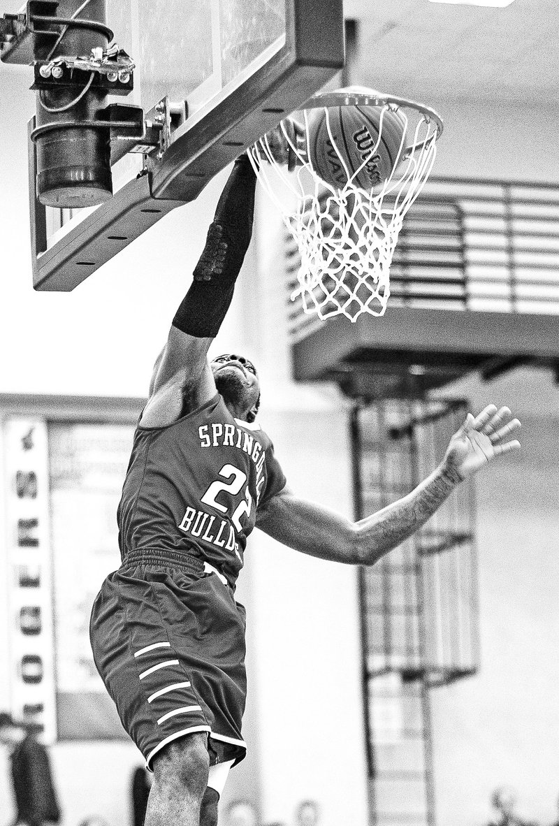  Special To NWA Media David J. Beach D.J. Evans of Springdale High dunks the ball on a fastbreak Friday against Rogers High at Rogers.