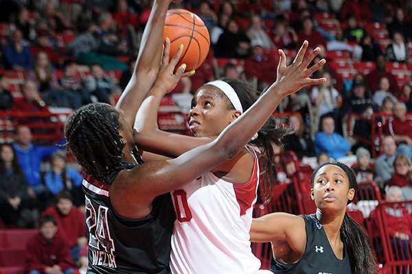 Arkansas' Jessica Jackson, right, runs through South Carolina's Aleighsa Welch Thursday, Jan. 2, 2014, during the second half of the game at Bud Walton Arena in Fayetteville.