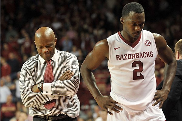 Arkansas coach Mike Anderson and Arkansas forward Alandise Harris talk on the sidelines after Arkansas turned the ball over late in the overtime period of Saturday afternoon's game against Florida at Bud Walton Arena in Fayetteville.