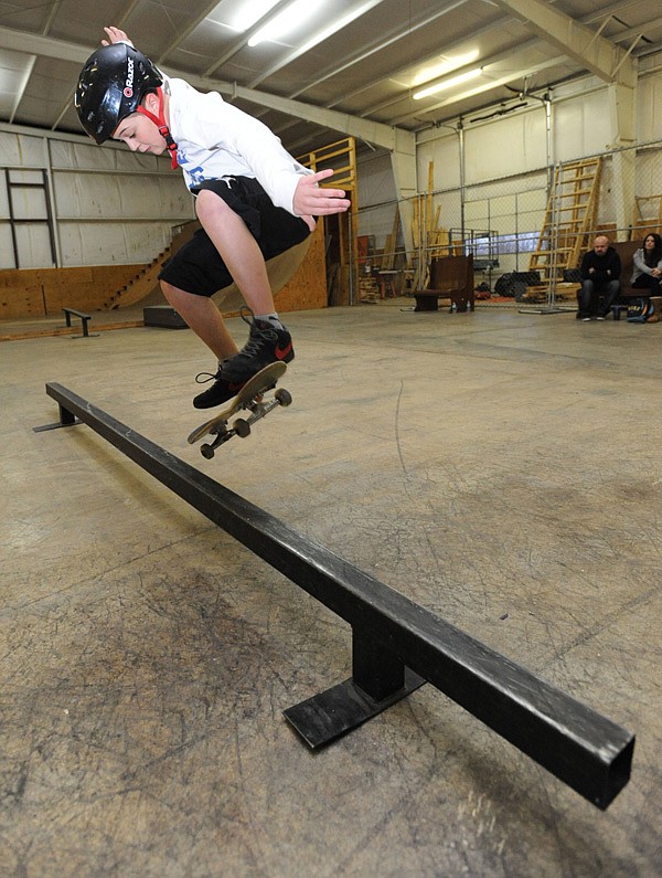 Dante Gales, 10, of Harrison leaps to ride along a metal rail while skating Friday, Jan. 10, 2014, at The Skate Station in Fayetteville.
