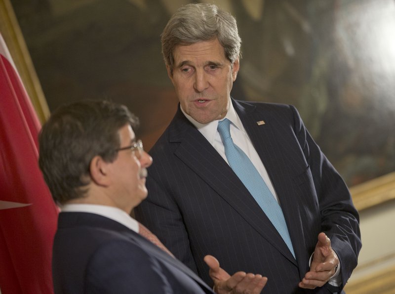 U.S. Secretary of State John Kerry, right, speaks with Turkish Foreign Minister Ahmet Davutoglu, left, at the US Ambassador residence in Paris, France, Sunday, Jan. 12, 2014. Kerry is in Paris to attend a two-day meeting on Syria to rally international support for ending the three-year civil war in Syria. (AP Photo/Pablo Martinez Monsivais, Pool)