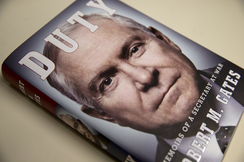 The book entitled: "Duty: Memoirs of a Secretary of War," by former Defense Secretary Robert Gates is seen in Washington, Wednesday, Jan. 8, 2014. The White House is bristling over former Defense Secretary Robert Gates' new memoir accusing President Barack Obama of showing too little enthusiasm for the U.S. war mission in Afghanistan and sharply criticizing Vice President Joe Biden's foreign policy instincts. (AP Photo/Jacquelyn Martin)