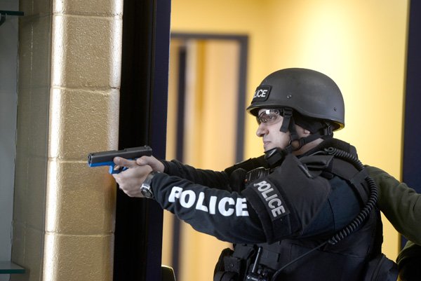 A Springdale Police officer watches a doorway during an active shooter training scenario Thursday, Jan. 2, 2014 at Shiloh Christian School in Springdale. Several members of both police and fire departments and many people serving as students and teachers in the school helped in the training. Police used airsoft guns and others loaded with blanks.