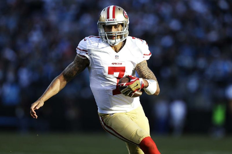 San Francisco 49ers quarterback Colin Kaepernick (7) carries the ball against the Carolina Panthers during the second half of a divisional playoff NFL football game, Sunday, Jan. 12, 2014, in Charlotte, N.C. (AP Photo/Gerry Broome)