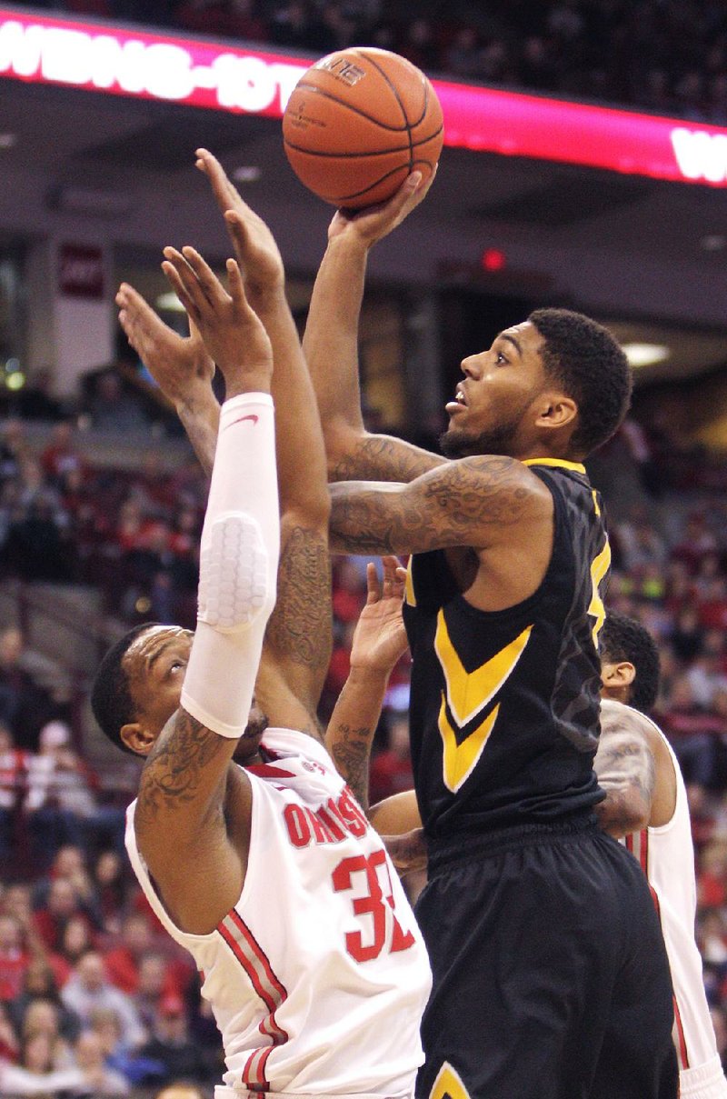 Iowa's Roy Devyn Marble, right, shoots over Ohio State's Lenzelle Smith during the first half of an NCAA college basketball game on Sunday, Jan. 12, 2014, in Columbus, Ohio. (AP Photo/Jay LaPrete)