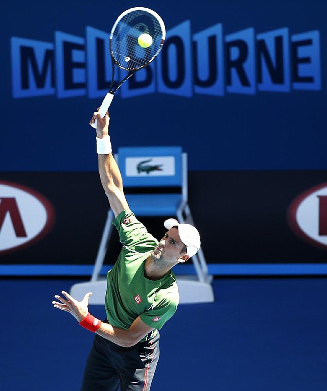 Novak Djokovic of Serbia serves during a training session ahead of the Australian Open tennis championship in Melbourne, Australia, Sunday, Jan. 12, 2014. (AP Photo/Eugene Hoshiko)