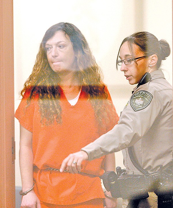 FILE PHOTO JASON IVESTER 
Heather Swain is led into the courtroom Jan. 30 at the Washington County jail in Fayetteville for arraignment. Swain’s capital murder trial is scheduled to begin this morning.