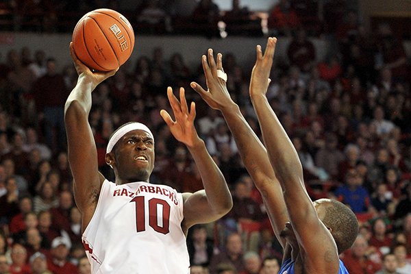 Arkansas forward Bobby Portis pulls up for a jump shot over Florida defender Dorian-Finney-Smith during the second half of Saturday afternoon's game at Bud Walton Arena in Fayetteville.