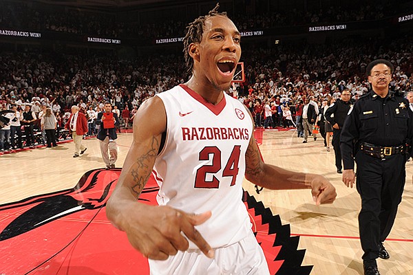 Michael Qualls celebrates following Arkansas' 87-85 overtime win over No. 13 Kentucky on Thursday at Bud Walton Arena in Fayetteville. 