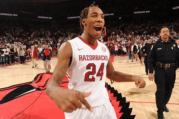 Michael Qualls celebrates following Arkansas' 87-85 overtime win over No. 13 Kentucky on Thursday at Bud Walton Arena in Fayetteville. 