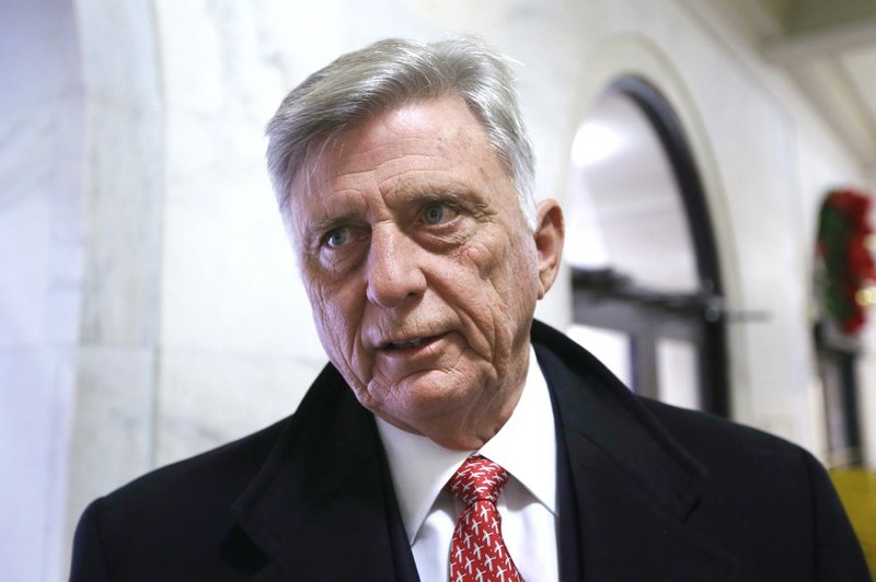 Arkansas Gov. Mike Beebe pauses in a hallway at the Arkansas state Capitol in Little Rock to comment about the state revenue report Friday, Jan. 3, 2014. 