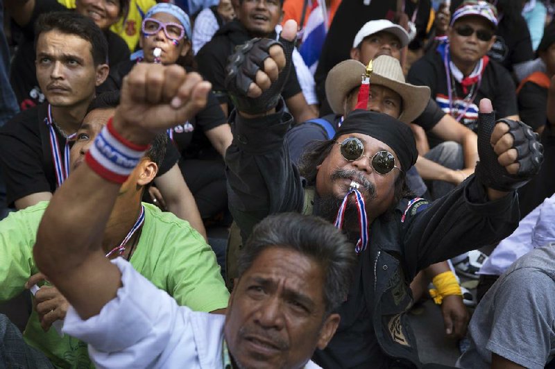 Anti-government protesters participate in a sit-in outside the Royal Thai Police headquarters Tuesday in Bangkok. Prime Minister Yingluck Shinawatra said she would not yield to pressure. 