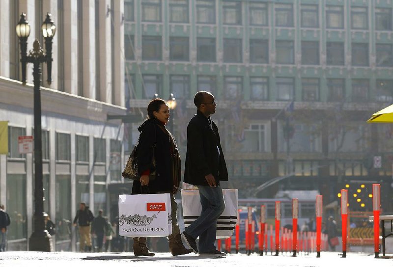 Shoppers cross a street in San Francisco on Christmas Eve in 2013. Retail sales beat forecasts for December despite bad weather and a drop in automobile sales. 