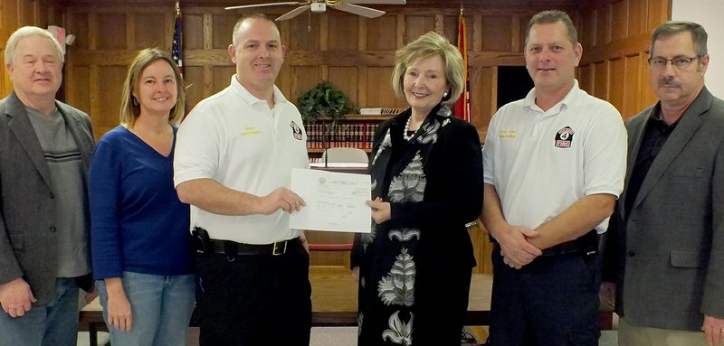 TIMES photograph by Annette Beard State Senator Cecile Bledsoe presented a check for $43,500 to Fire Chief Jamie Baggett and assistant Fire Chief Dino Collins Monday. Joining in the presentation were Ray Easley and Nadine Telgemeier, city council members, and Mayor Jackie Crabtree.