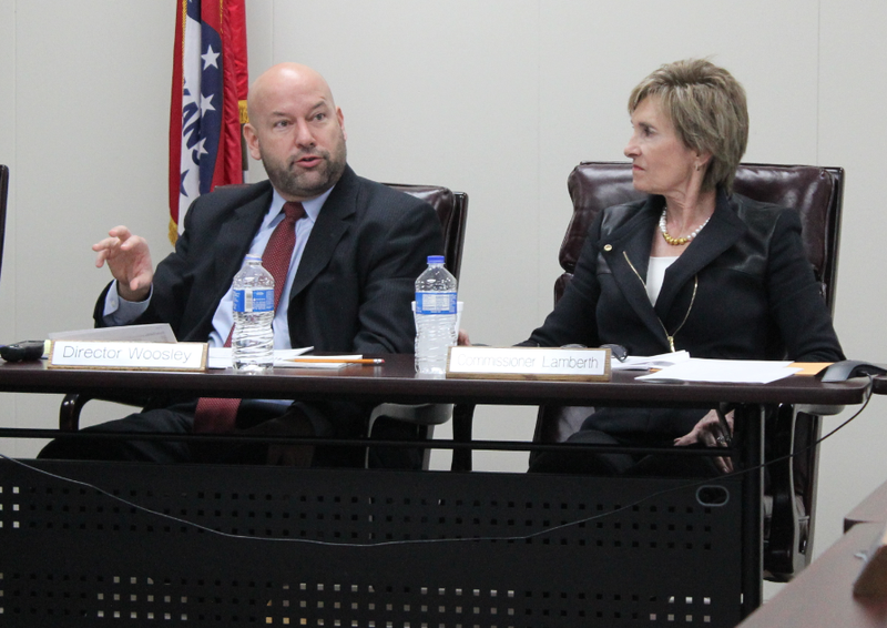 Arkansas Scholarship Lottery Director Bishop Woosley speaks while commissioner Dianne Lamberth looks on during a meeting of the lottery commission Wednesday. 