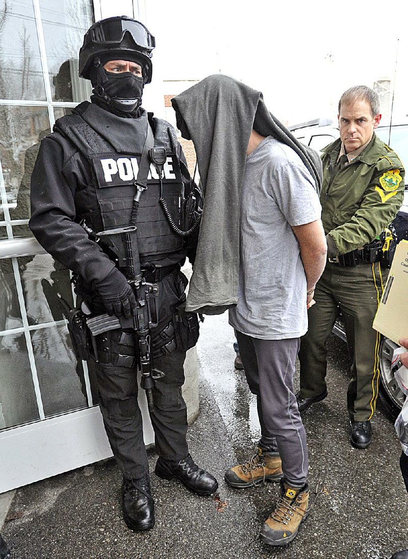 Police in Bennington, Vt., take a suspect into custody in January 2013 during a sweep that rounded up dozens of drug suspects in southwestern Vermont. The state ranks as one of the top 10 for the abuse of illicit drugs. 
