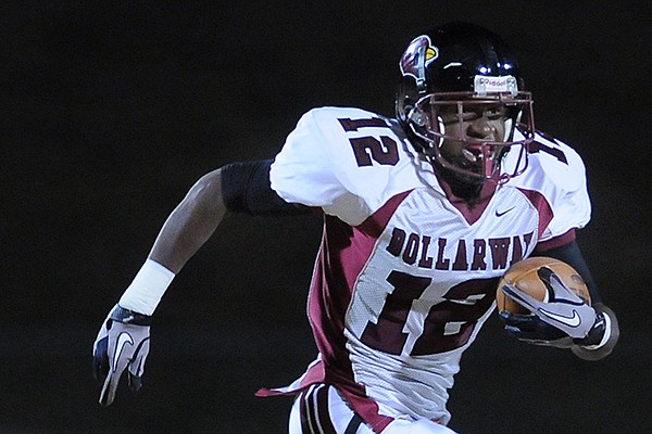 Pine Bluff Dollarway High School's Joshua Liddell, 12, outruns Dallas Kerley, 34, of Gravette High School Friday, Nov. 25, 2011, at Lion Stadium in Gravette. The Cardinals of Dollarway won the game, 20-13.