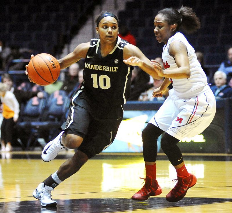 Vanderbilt's Christina Foggie (10) is defended by Mississippi's Valencia McFarland (3) during an NCAA college basketball game in Oxford, Miss., Thursday, Jan. 16, 2014. (AP Photo/Oxford Eagle, Bruce Newman) MAGAZINES OUT; NO SALES; MANDATORY CREDIT