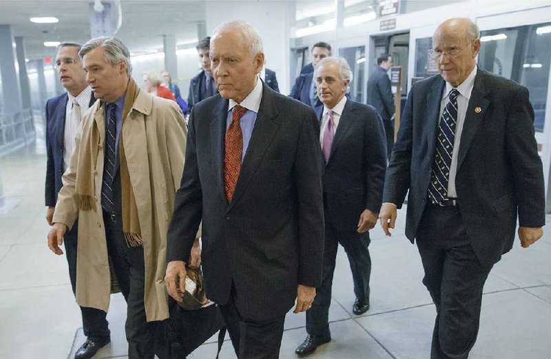 From left, Sen. John Boozman, R-Ark., Sen. Sheldon Whitehouse, D-R.I., Sen. Orrin Hatch, R-Utah, Sen. Bob Corker, R-Tenn., and Sen. Pat Roberts, R-Kan., arrive at the Capitol as the Senate votes to approve a $1.1 trillion spending package, the Omnibus Appropriations Act, a bipartisan compromise that all but banishes the likelihood of an election-year government shutdown, at the Capitol in Washington, Thursday, Jan. 16, 2014.  The legislation is a follow-up to the budget compromise the two parties pushed through Congress in December that set overall spending limits for the next two years.   (AP Photo/J. Scott Applewhite)