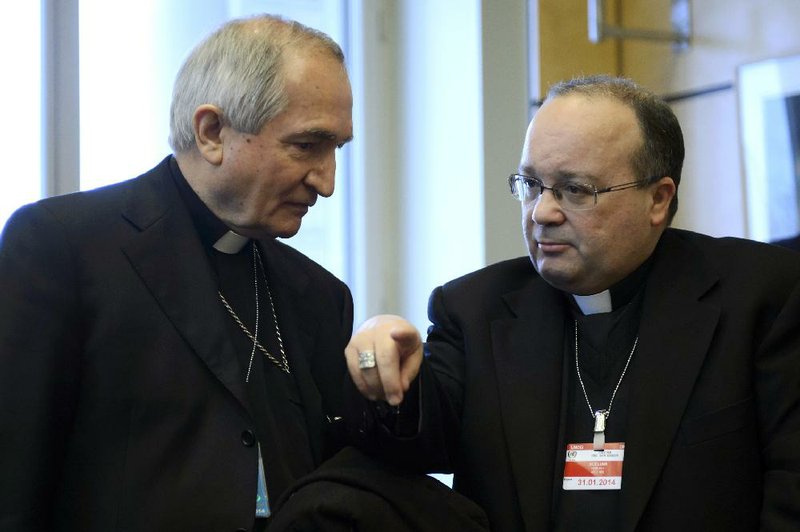 Vatican's UN Ambassador Monsignor Silvano Tomasi, left, speaks with Former Vatican Chief Prosecutor of Clerical Sexual Abuse Charles Scicluna, right, prior to the start of a questioning over clerical sexual abuse of children at the headquarters of the office of the High Commissioner for Human Rights, OHCHR, in Geneva, Switzerland, Thursday, Jan. 16, 2014. The Vatican came under blistering criticism from a U.N. committee Thursday for its handling of the global priest sex abuse scandal, facing its most intense public grilling ever over allegations that it protected pedophile priests at the expense of victims. (AP Photo/Keystone, Martial Trezzini)