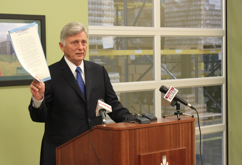 Gov. Mike Beebe holds a proclamation marking the 30th anniversary of the Arkansas Foodbank during a news conference at its Little Rock headquarters Friday.