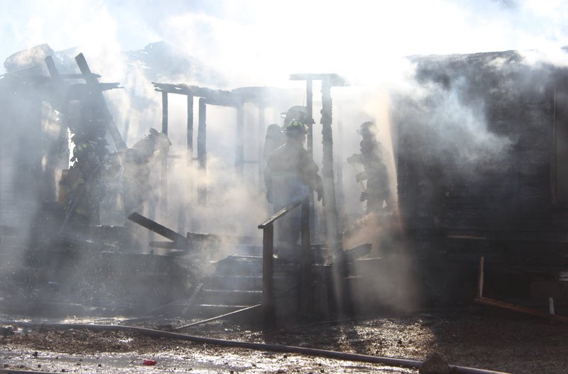 Firefighters work Friday, Jan. 17, 2014, to extinguish a blaze at the home at 122 Morning Glory St. in North Little Rock. The home's owner Shelia Dednam said she was not at the residence when the fire started. 