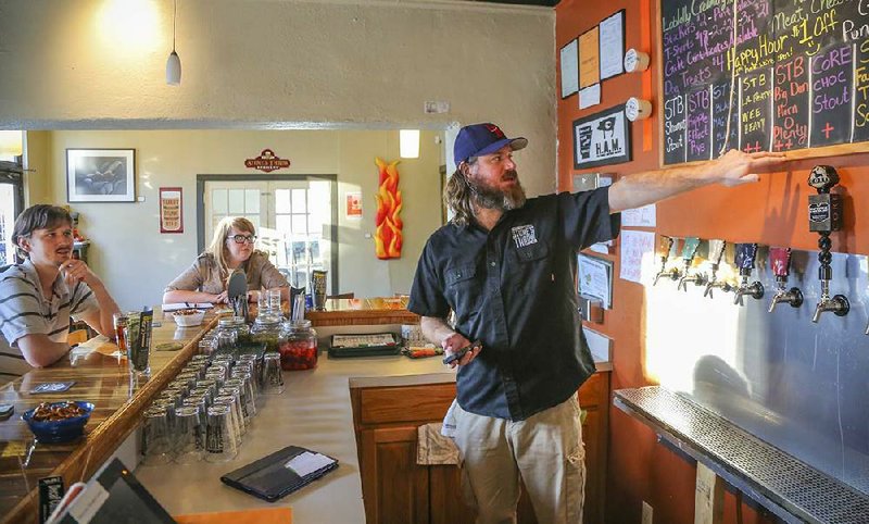 Ian Beard, co-owner of Stone’s Throw Brewing, describes the beers available Thursday in the Stone’s Throw taproom at Ninth and Rock streets in Little Rock. 