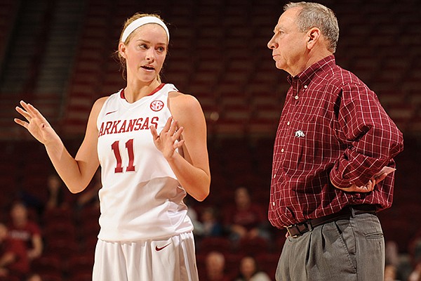 Arkansas guard Calli Berna, left, speaks with coach Tom Collen during the second half of play against Mississippi State Sunday, Jan. 12, 2014, in Bud Walton Arena in Fayetteville.