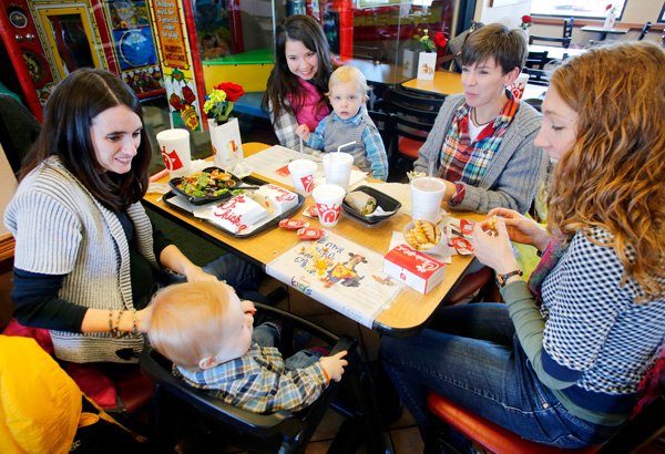 Emily Wurpts (cq) (counter clockwise from left) turns to her son Jayden, 1, as they have lunch with Stephanie Frasier, Hilary (cq) McCasland, Thad Frasier, 1, and Amy Allert, all of Fayetteville, Friday afternoon Jan. 17, 2014 at Chick-fil-A at Razorback Road (cq) in Fayetteville. The Fayetteville Advertising and Promotion Commission collected more than $2.6 million in hotel, motel and restaurant taxes in 2013. That's a 4.43 percent increase compared to 2012.