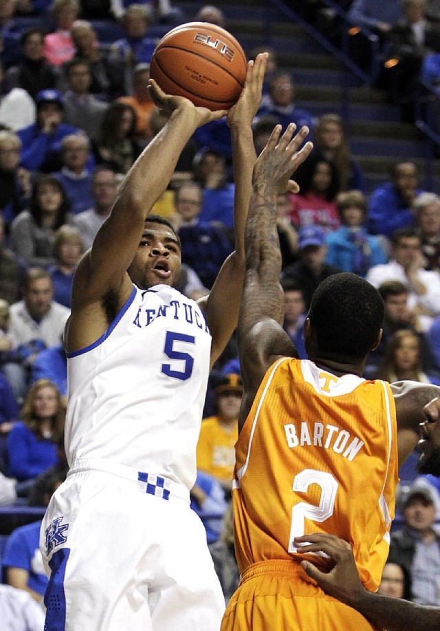 Kentucky's Andrew Harrison (5) shoots under pressure from Tennessee's Antonio Barton (2) during the second half of an NCAA college basketball game, Saturday, Jan. 18, 2014, in Lexington, Ky. Kentucky won 74-66. (AP Photo/James Crisp)
